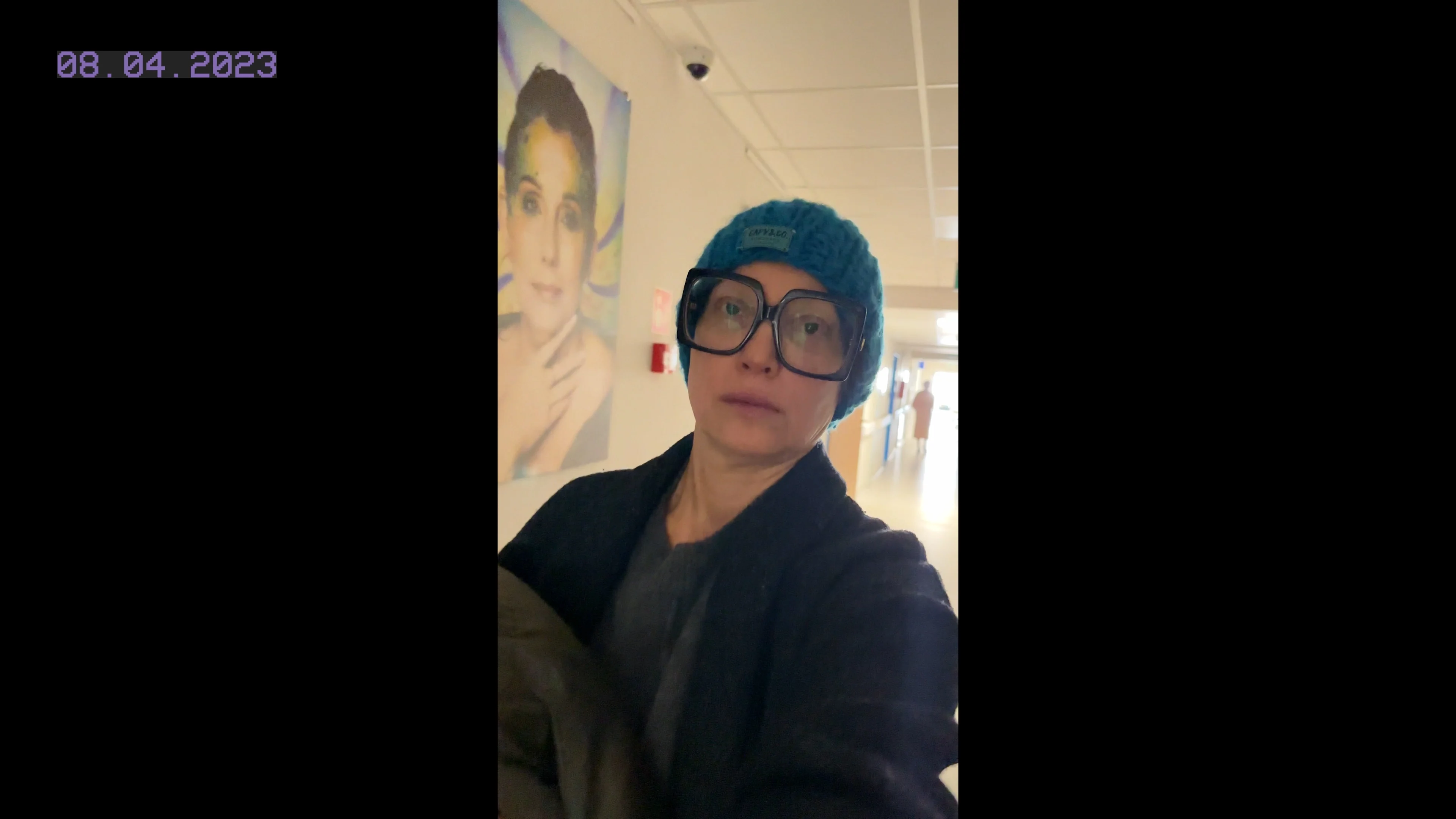 Magda Atkins in the hospital, wearing a cap