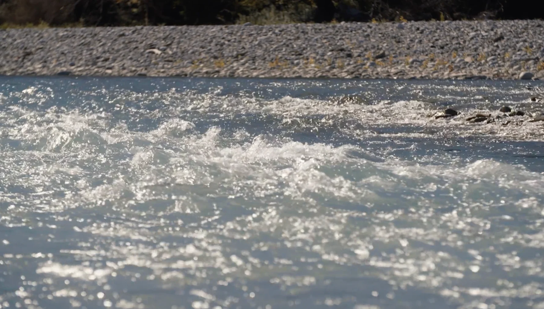 A frame from 'Until the Last Drop' showing turbulent river water